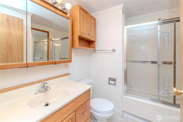 a bathroom with a sink mirror vanity and toilet