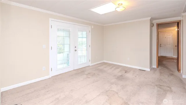an empty room with windows and closet
