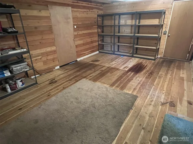 a view of a room with wooden floor