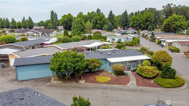 an aerial view of a house with garden space and lake view
