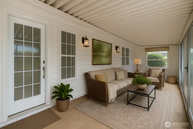 a living room with furniture potted plant and a flat screen tv