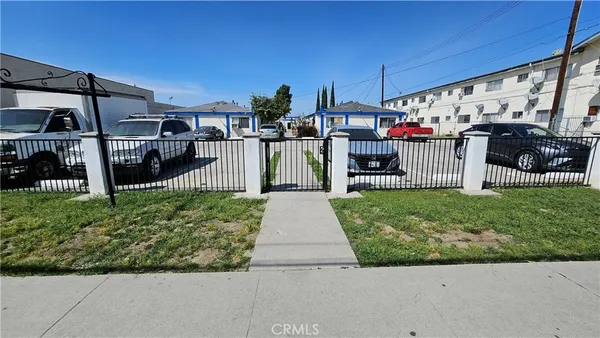a front view of a house with a garden and plants