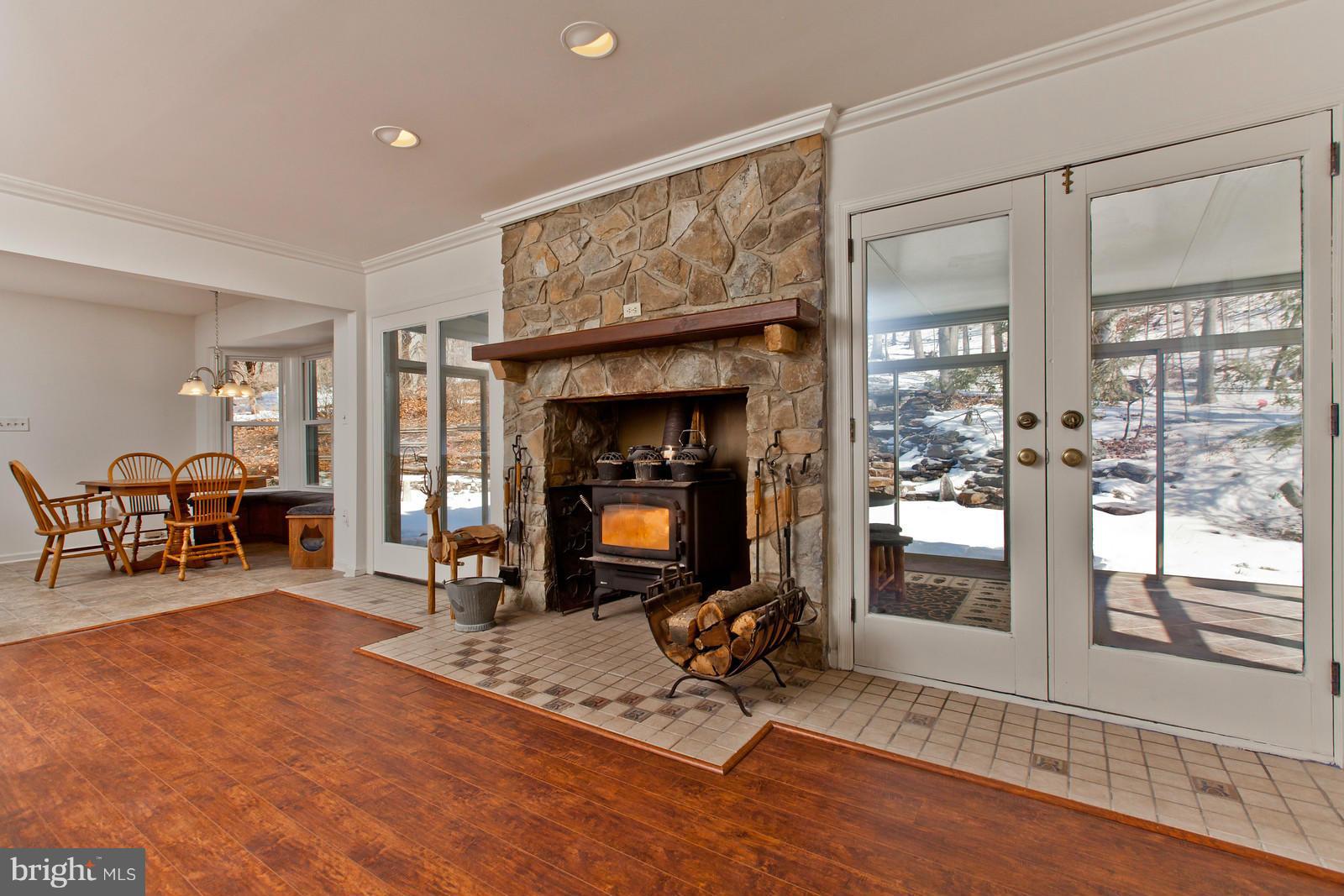 3880 Point Of Rocks Road Jefferson, MD 21755 - Photo 11 of 30 a living room with furniture a dining table and a fireplace