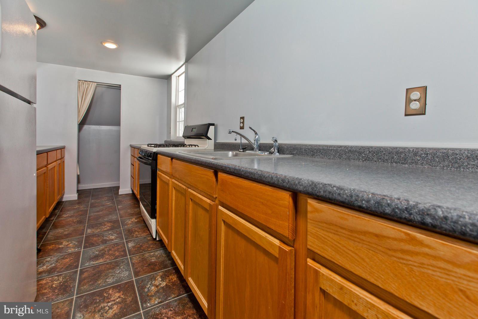 3880 Point Of Rocks Road Jefferson, MD 21755 - Photo 21 of 30 a kitchen with stainless steel appliances granite countertop a sink and a refrigerator