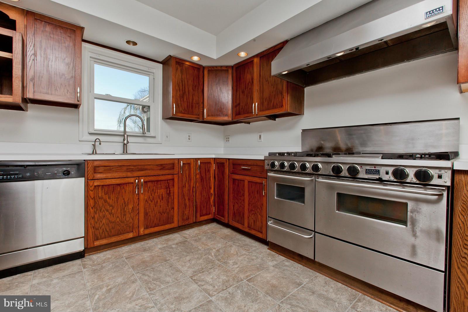 3880 Point Of Rocks Road Jefferson, MD 21755 - Photo 7 of 30 a kitchen with stainless steel appliances granite countertop wooden cabinets stove top oven and sink