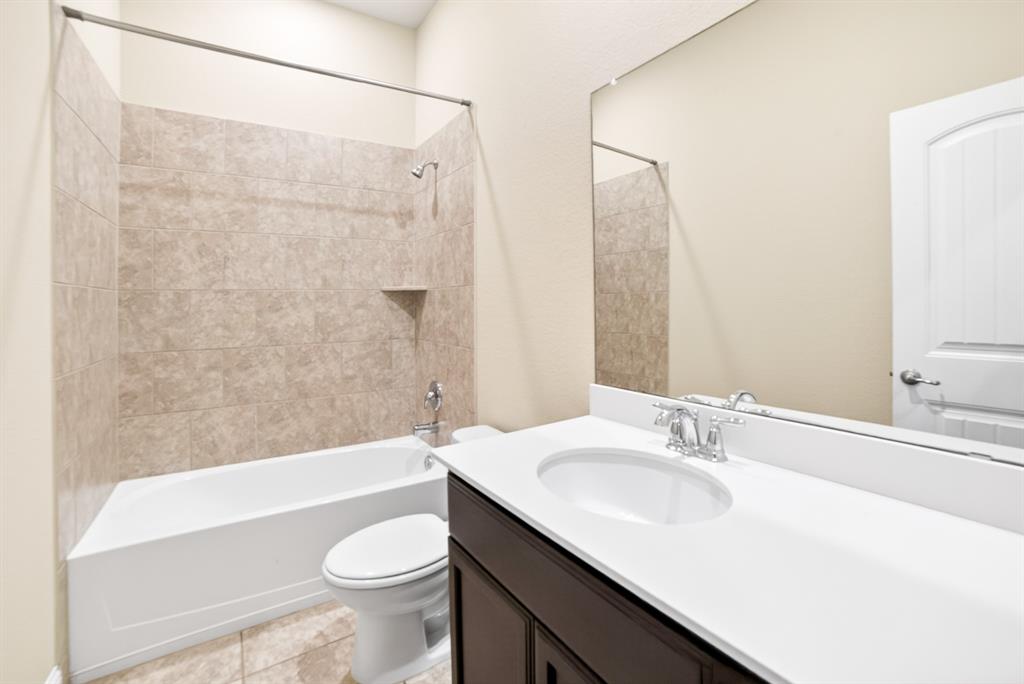 552 Winnetka Drive Oak Point, TX 75068 - Photo 13 of 40 a bathroom with a sink a toilet and shower