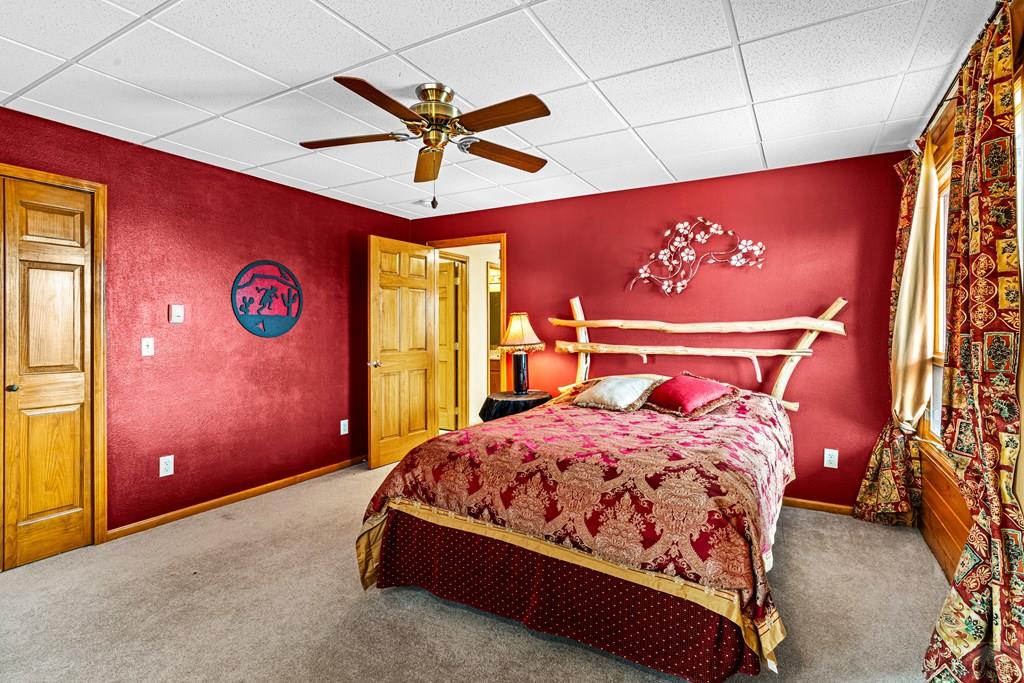 1301 Pheasant Loop Westcliffe, CO 81252 - Photo 20 of 27 a bedroom with a bed and a chandelier