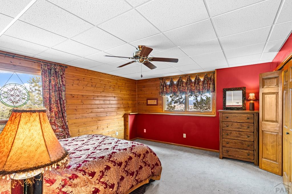 1301 Pheasant Loop Westcliffe, CO 81252 - Photo 21 of 27 a bedroom with a bed and a dresser
