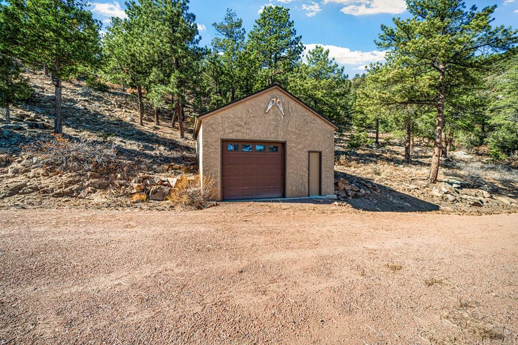1301 Pheasant Loop Westcliffe, CO 81252 - Photo 26 of 27 a view of a house with a yard and garage