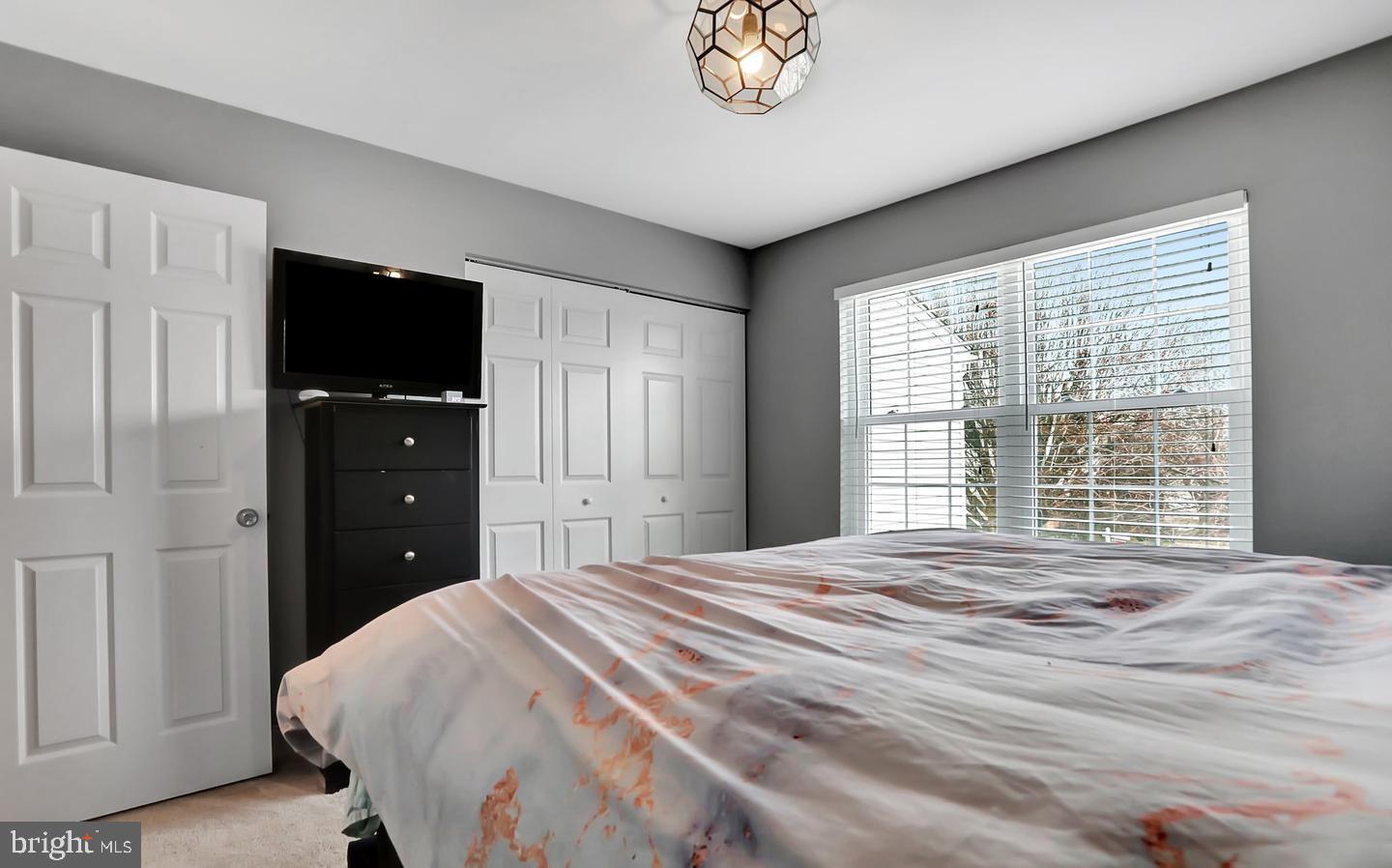 577 Lancaster Place Frederick, MD 21703 - Photo 13 of 19 a bedroom with a bed and a flat tv screen