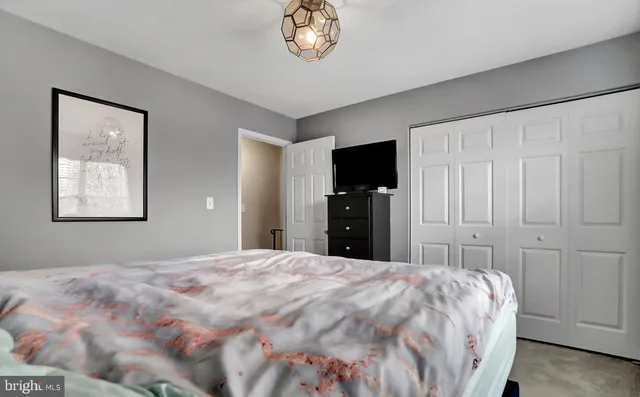 a bedroom with a large bed and a tv