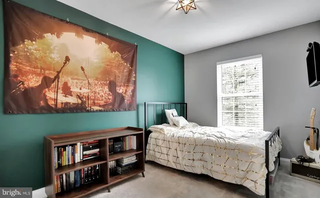 a bedroom with a bed window and a wall in it