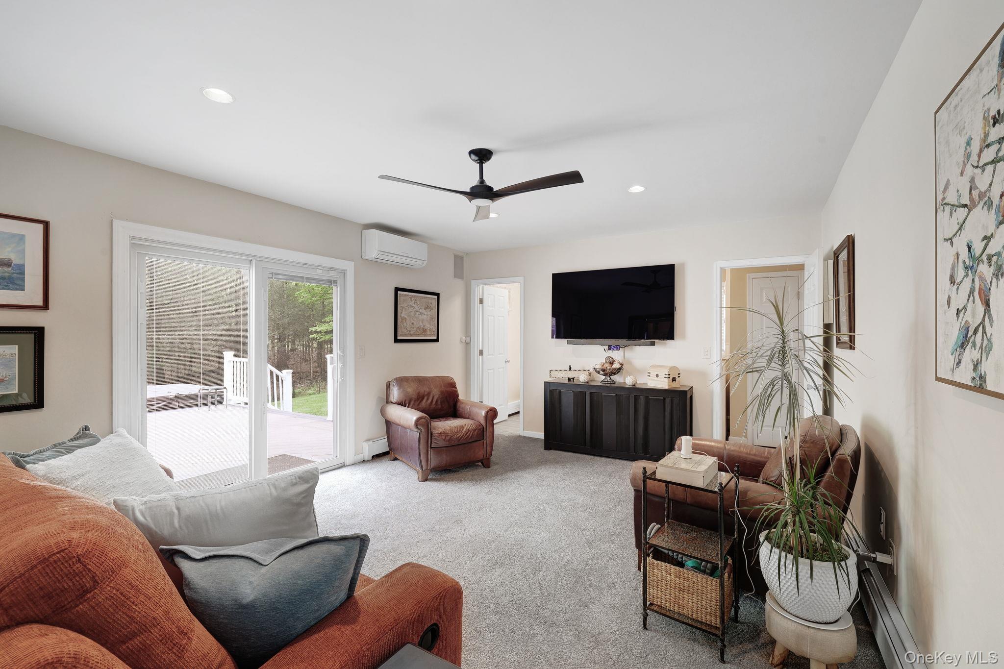 90 M And M Road Middletown, NY 10940 - Photo 20 of 50 a living room with furniture a flat screen tv and a large window