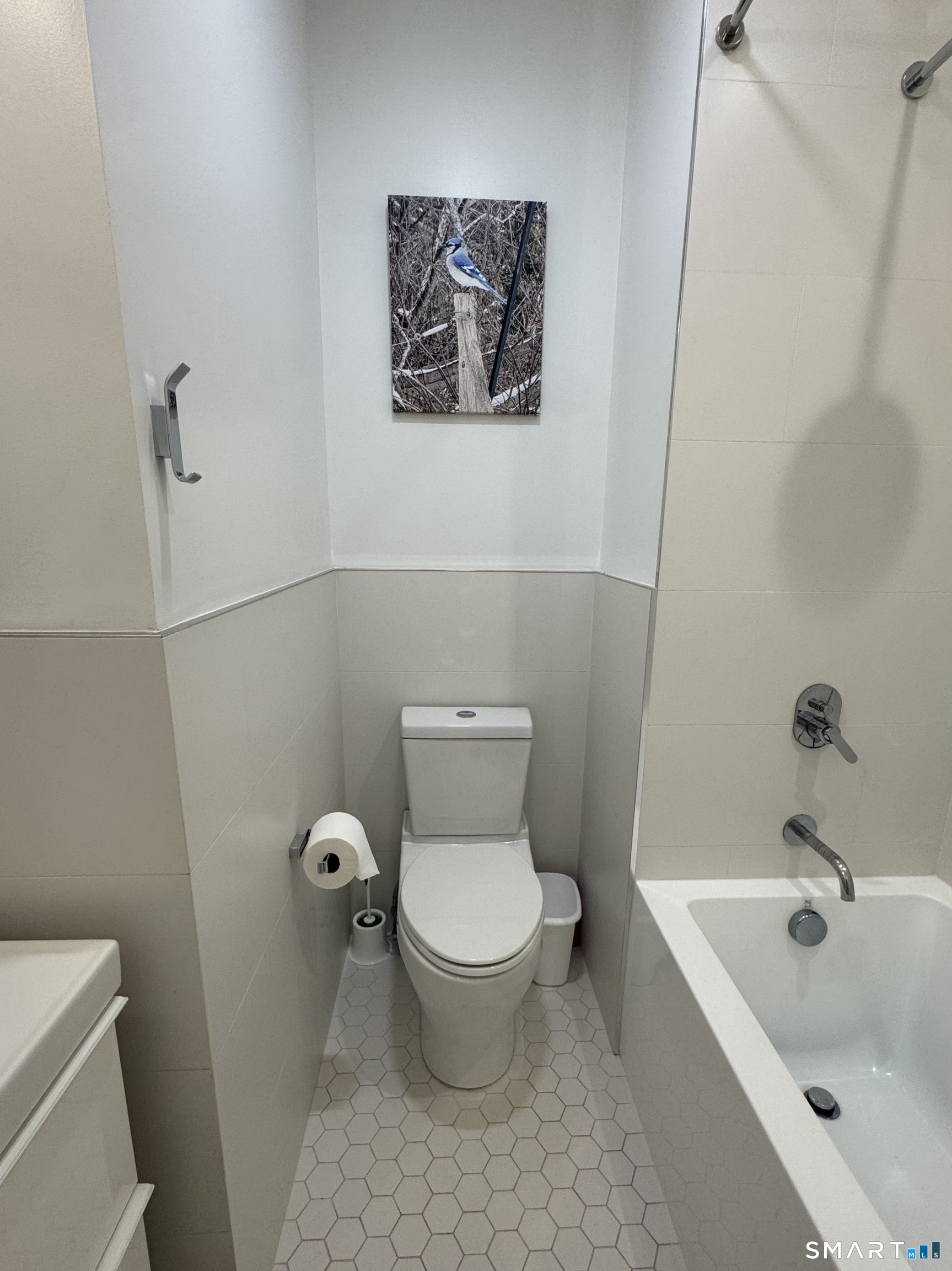 930 Cove Road, Unit 2 Stamford, CT 06902 - Photo 5 of 14 a white toilet sitting next to a bath tub