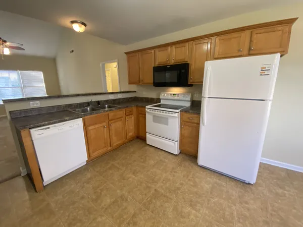 a kitchen with a refrigerator sink and microwave