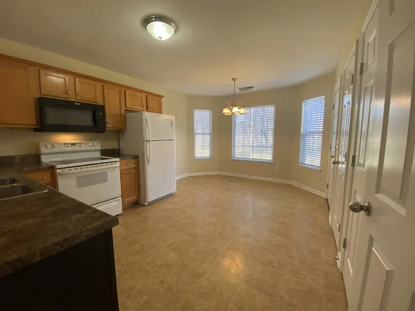 a view of a kitchen with a sink stove and refrigerator