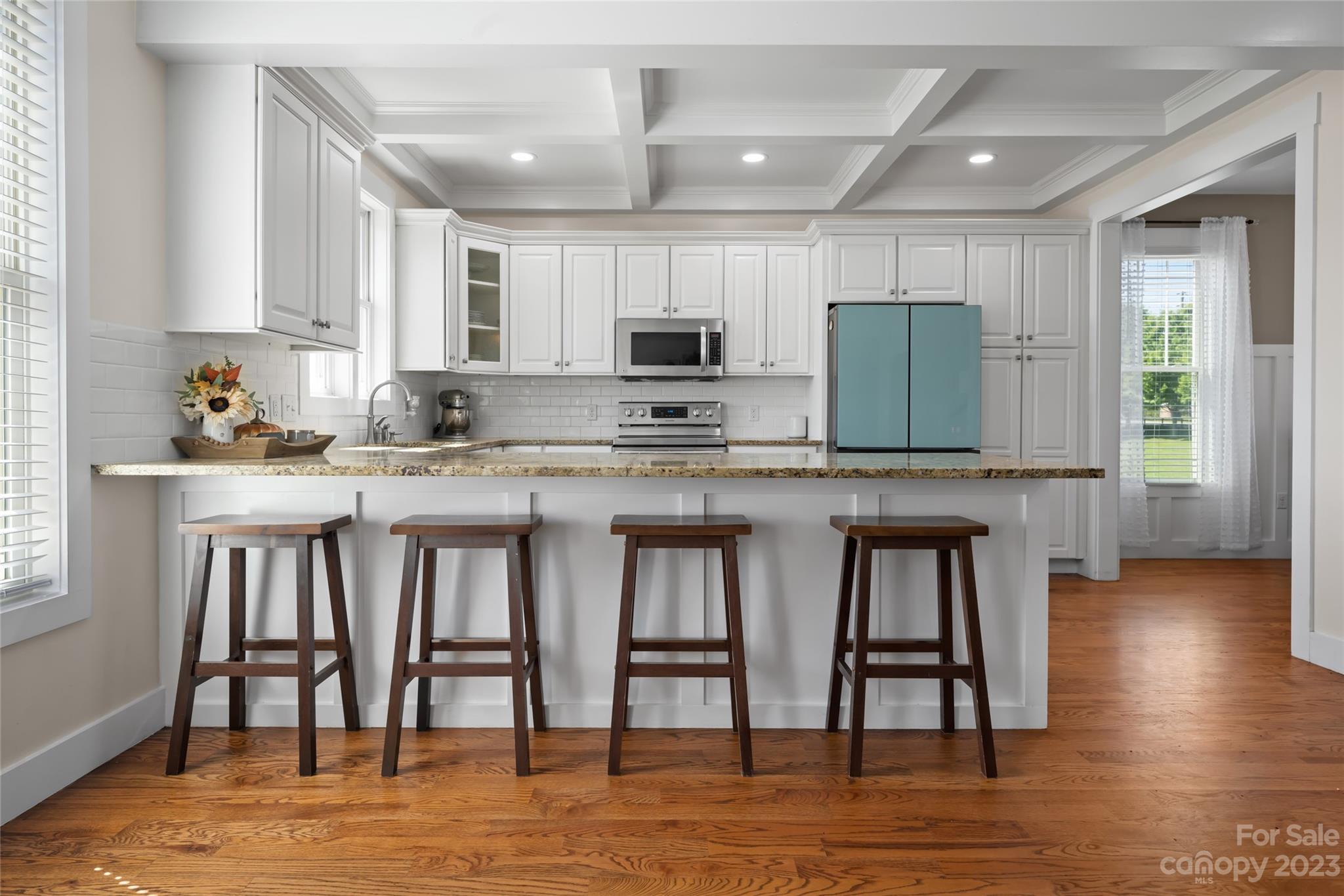 1480 Jenkins Valley Road Alexander, NC 28701 - Photo 13 of 40 a kitchen with stainless steel appliances granite countertop a stove top oven a sink a dining table and chairs