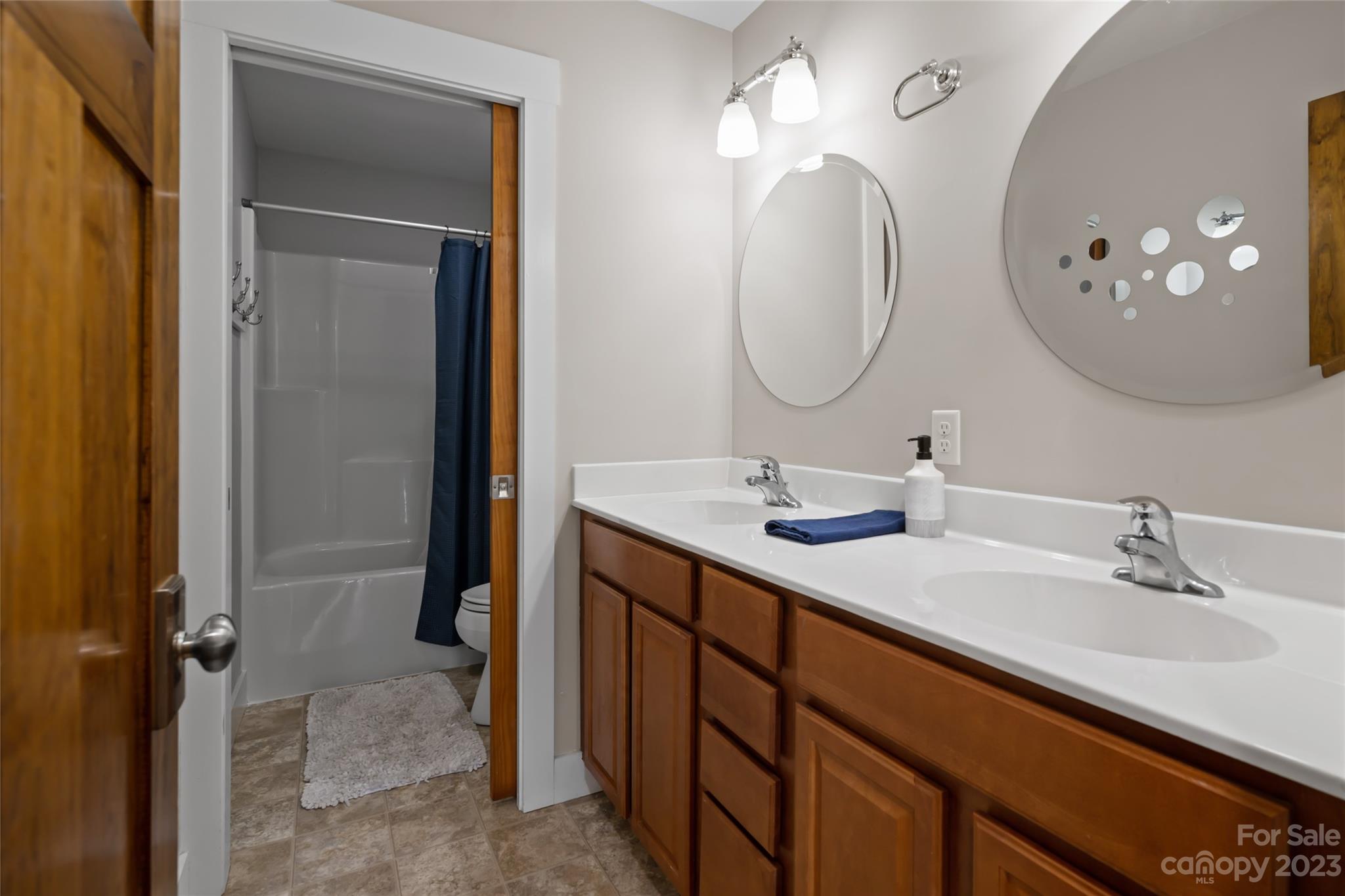 1480 Jenkins Valley Road Alexander, NC 28701 - Photo 22 of 40 a bathroom with a double vanity sink and a mirror