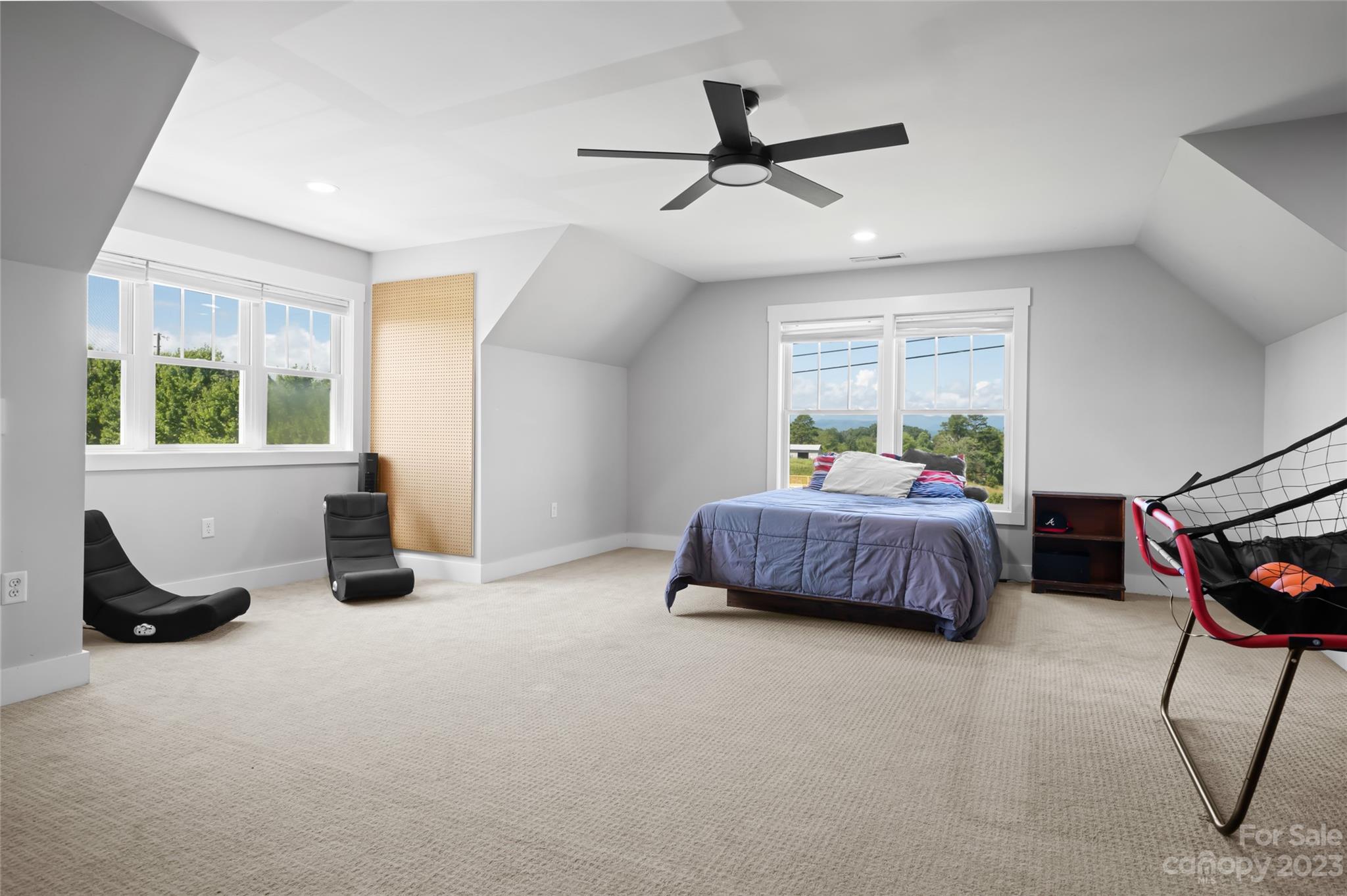 1480 Jenkins Valley Road Alexander, NC 28701 - Photo 26 of 40 a bedroom with a bed a chandelier and a window