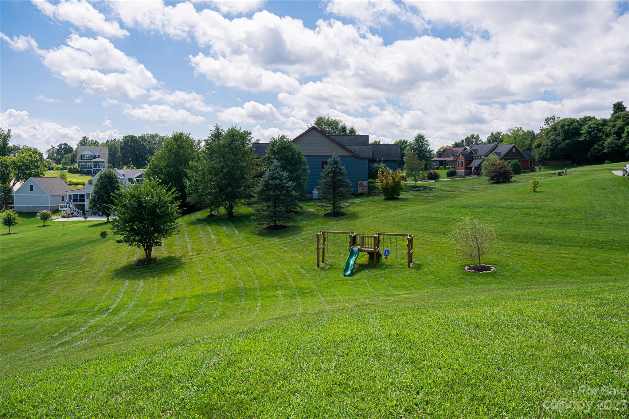 1480 Jenkins Valley Road Alexander, NC 28701 - Photo 37 of 40 a view of a golf course with chairs and a park
