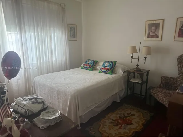 a bedroom with a bed and dresser