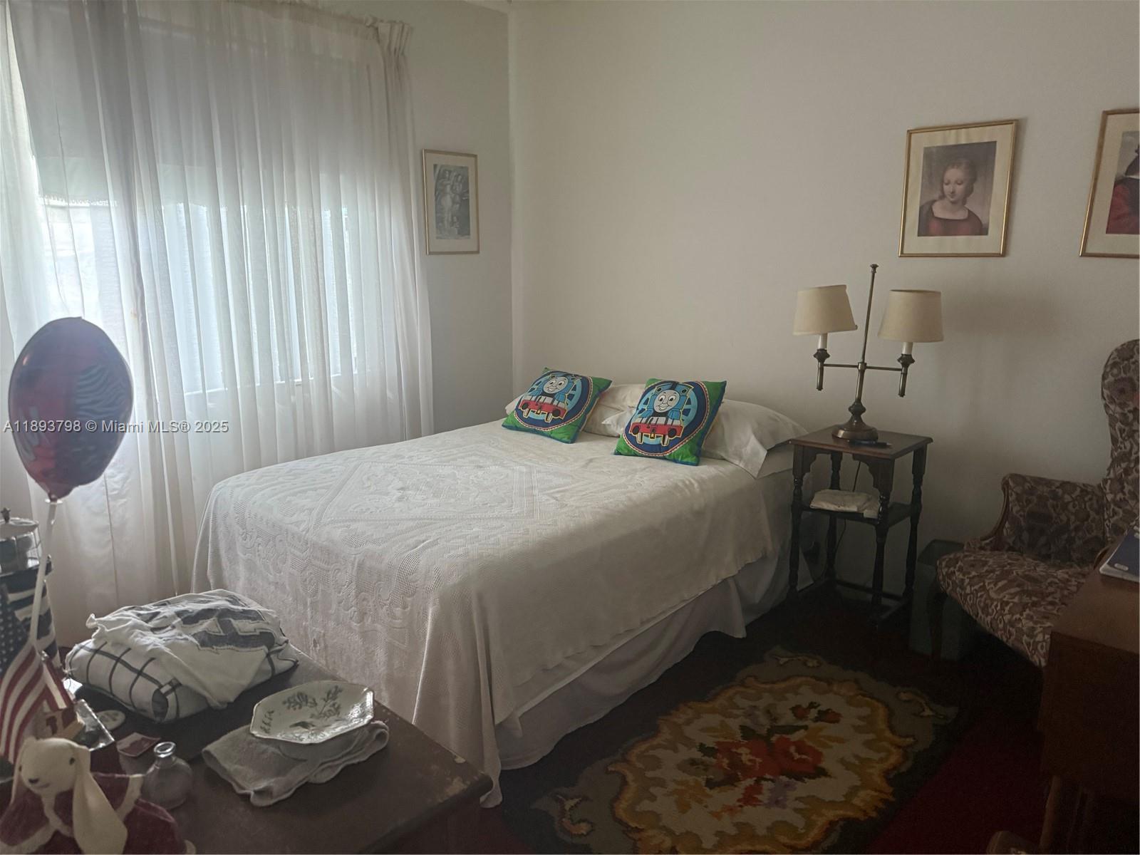 831 Northeast 207th Lane, Unit 2106 Miami, FL 33179 - Photo 10 of 13 a bedroom with a bed and dresser