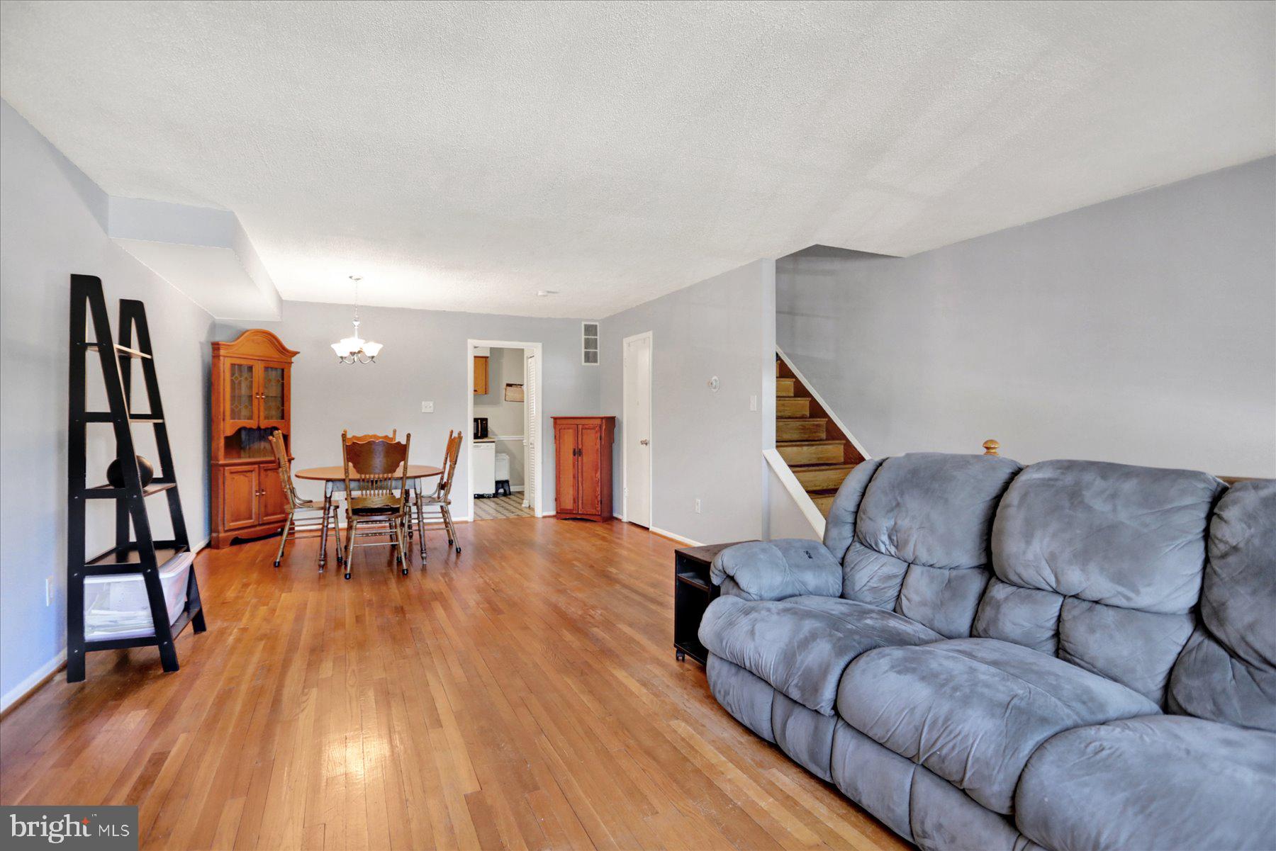 959 Elm Road Baltimore, MD 21227 - Photo 4 of 27 a living room with furniture and wooden floor
