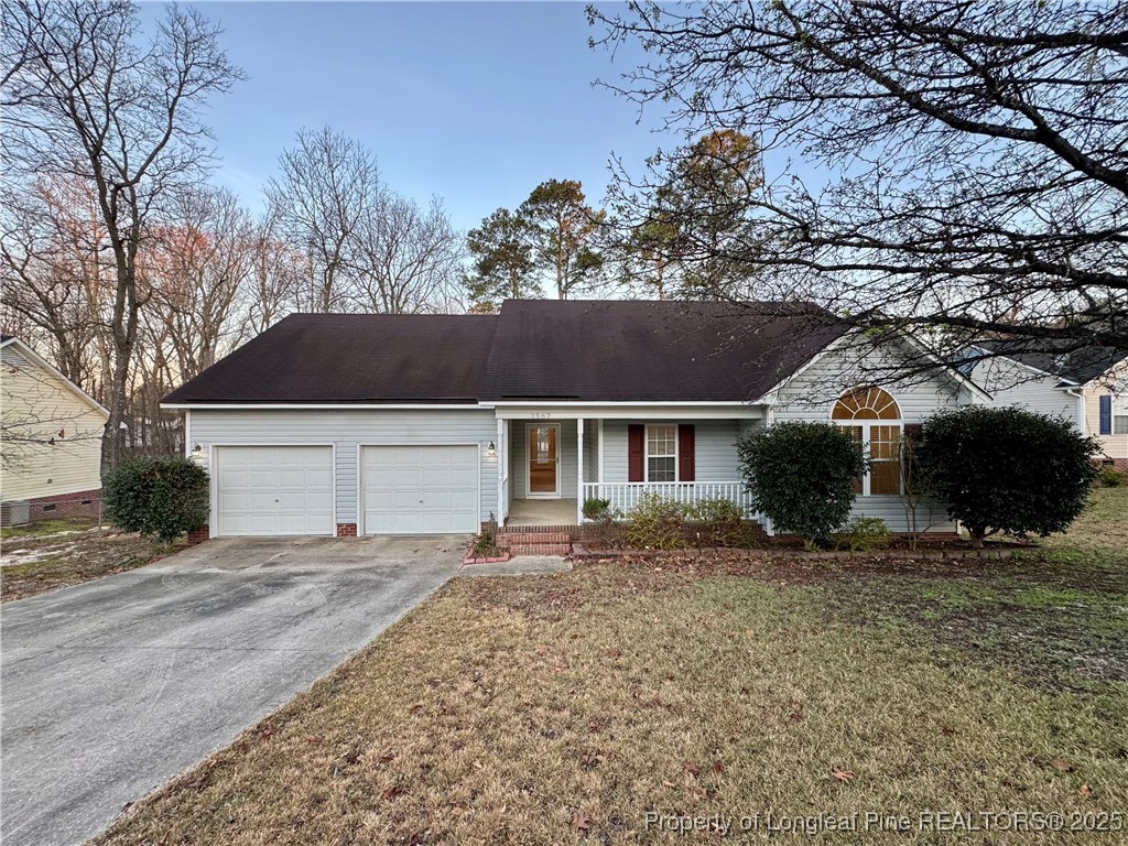 1567 Clan Campbell Drive Raeford, NC 28376 - Photo 1 of 21 a front view of a house with a yard