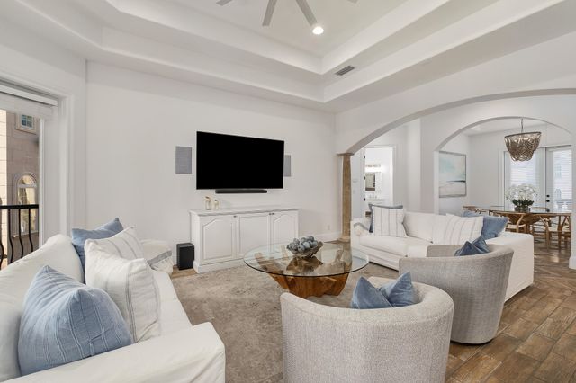 a view of a balcony with furniture and a potted plant
