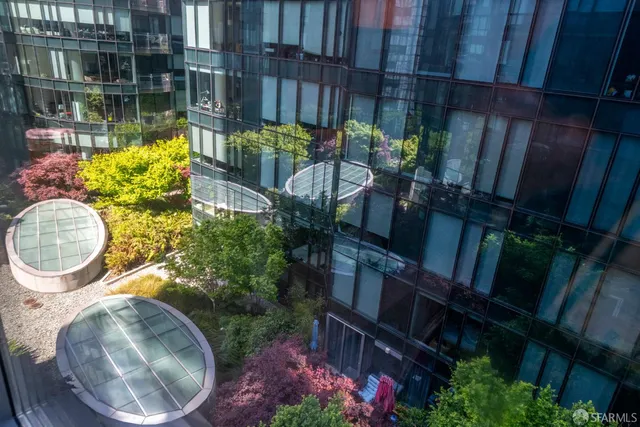 a backyard of a house with lots of green space and fountain