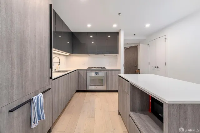 a kitchen with stainless steel appliances a sink and a refrigerator