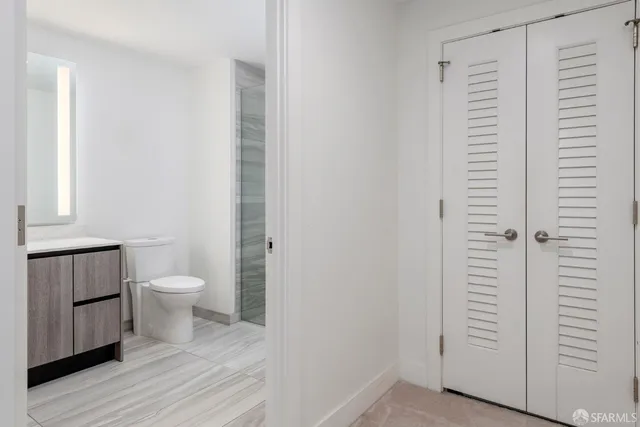 a bathroom with a toilet and a window