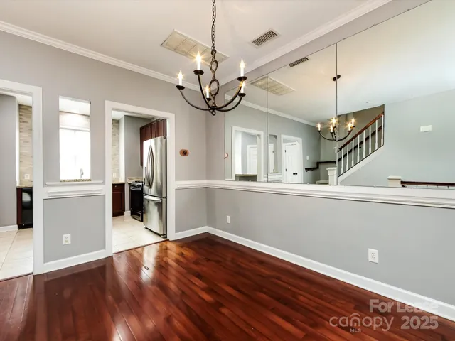a view of a room with wooden floor