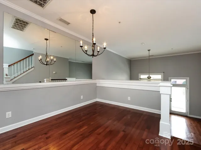 a view of a room with wooden floor and staircase