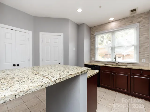 a kitchen with a sink and a wooden cabinets