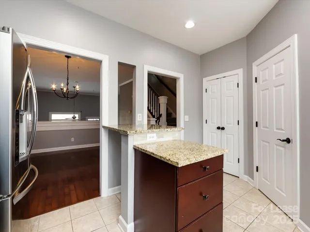 a bathroom with a granite countertop sink a mirror and shower