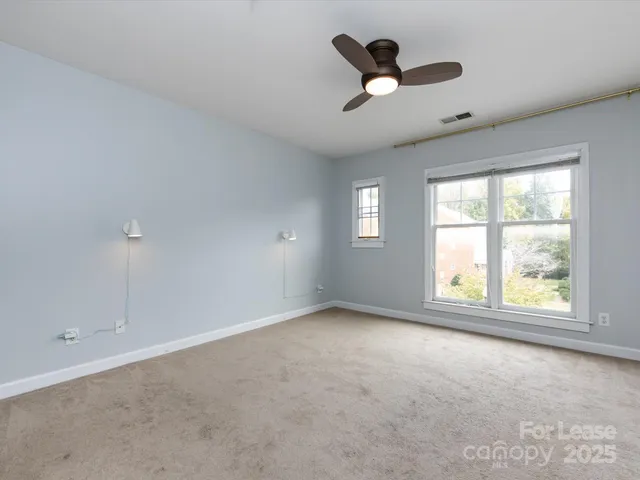 a view of empty room with ceiling fan