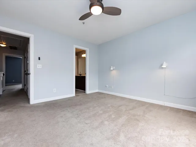 an empty room with closet and windows