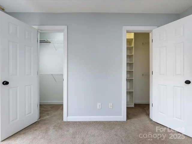 an empty room with closet and a bathroom