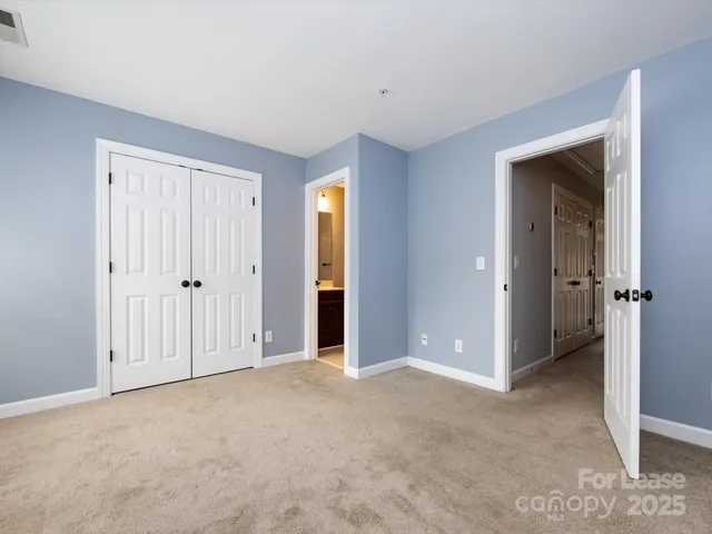 a view of an empty room with closet area
