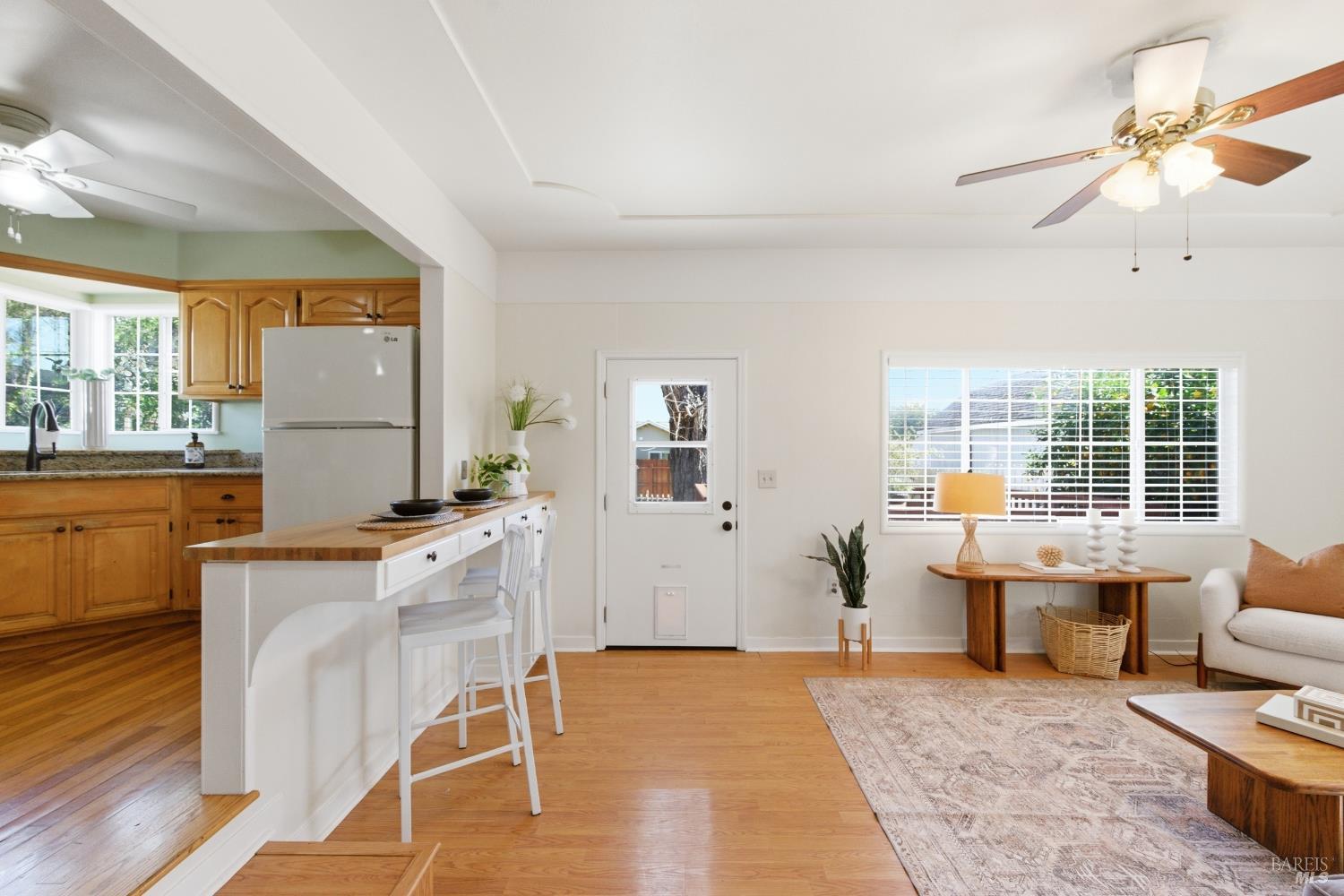 3188 Laurel Street Napa, CA 94558 - Photo 13 of 49 a kitchen with stainless steel appliances kitchen island granite countertop a stove a sink a dining table and chairs with wooden floor