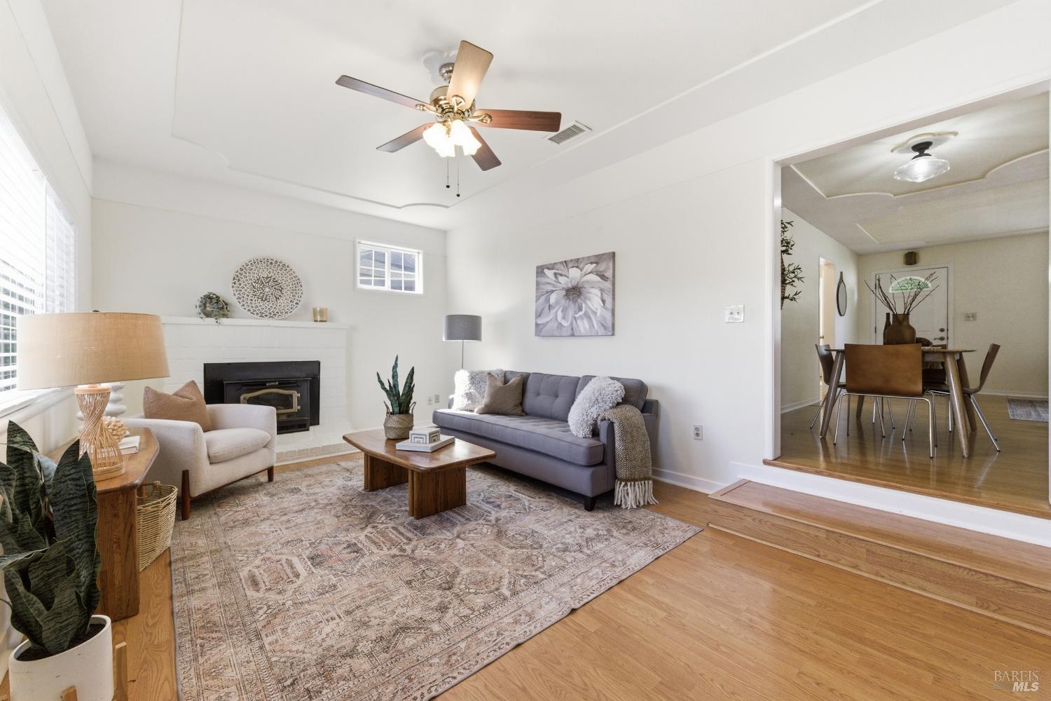3188 Laurel Street Napa, CA 94558 - Photo 14 of 49 a living room with furniture a fireplace and a chandelier