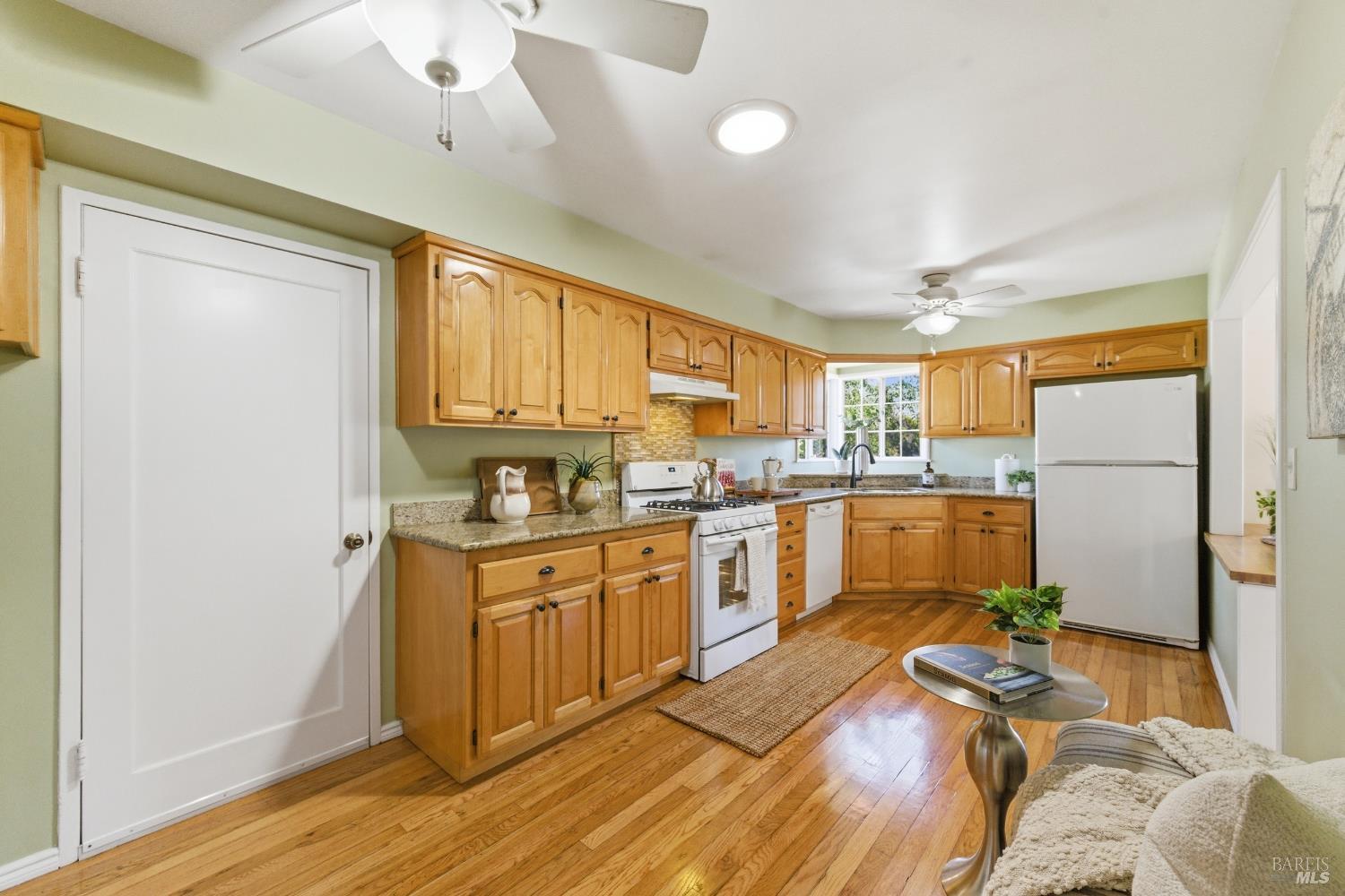3188 Laurel Street Napa, CA 94558 - Photo 18 of 49 a kitchen with stainless steel appliances granite countertop a refrigerator a sink dishwasher a stove with wooden cabinets and floor