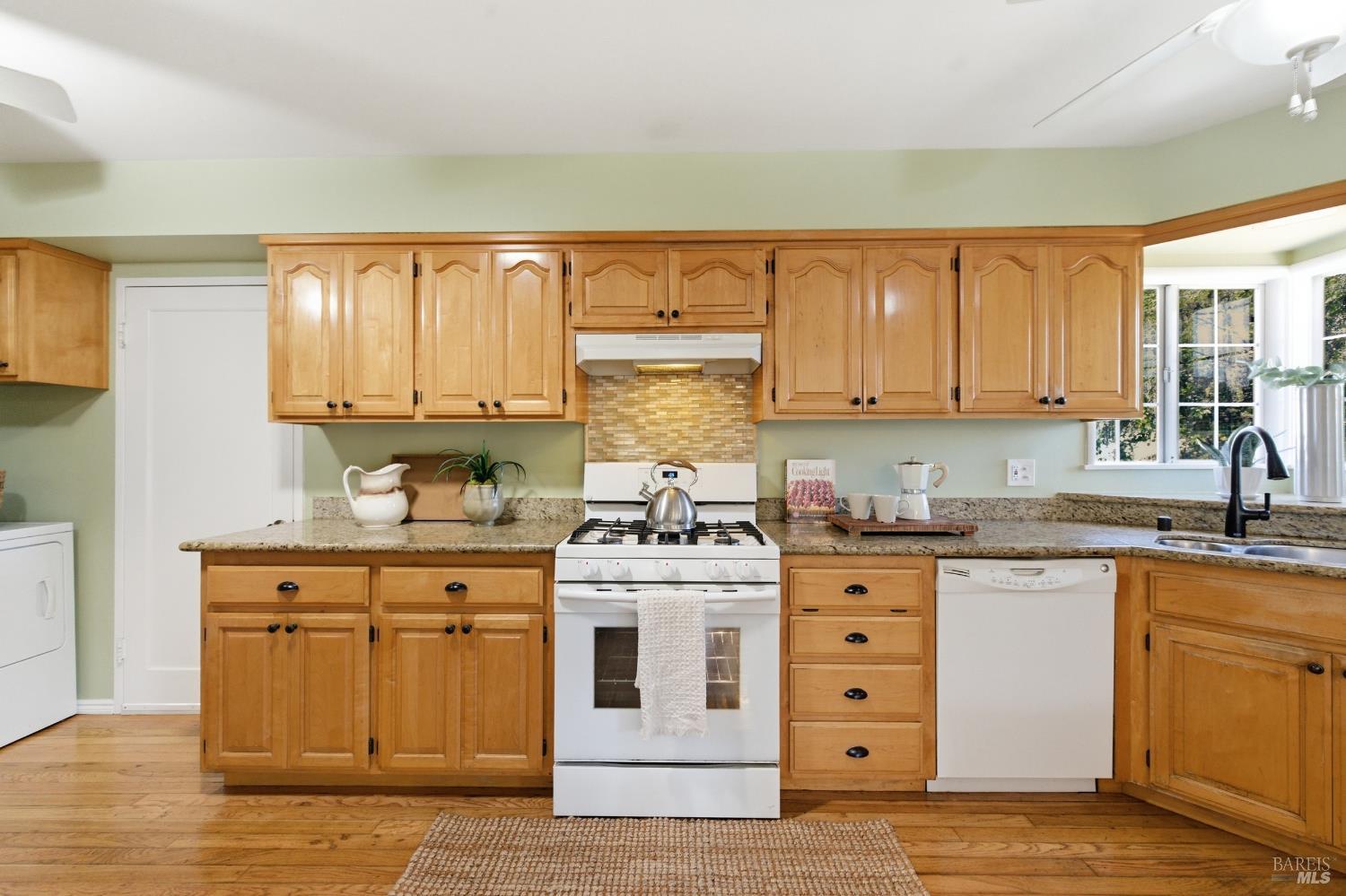 3188 Laurel Street Napa, CA 94558 - Photo 19 of 49 a kitchen with stainless steel appliances granite countertop a stove and a sink