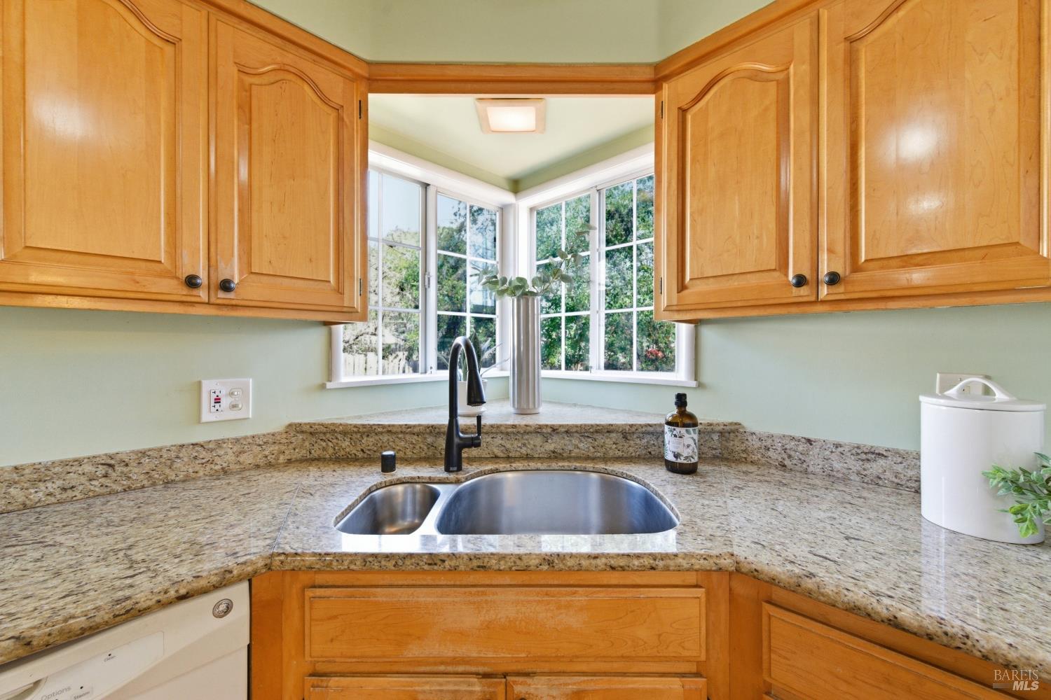 3188 Laurel Street Napa, CA 94558 - Photo 20 of 49 a kitchen with granite countertop a sink a counter space and cabinets