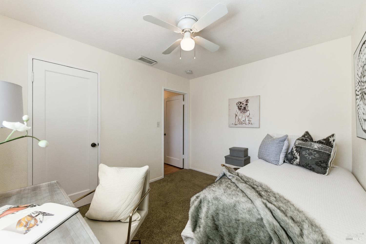 3188 Laurel Street Napa, CA 94558 - Photo 26 of 49 a bedroom with a bed and a chandelier