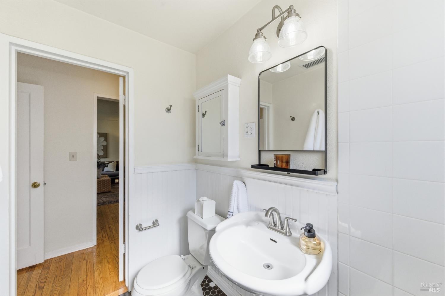 3188 Laurel Street Napa, CA 94558 - Photo 29 of 49 a bathroom with a sink a toilet and mirror