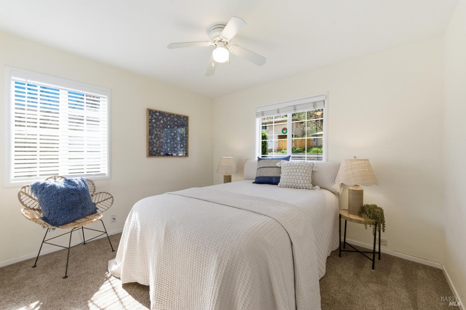 3188 Laurel Street Napa, CA 94558 - Photo 30 of 49 a bedroom with a bed and a chandelier