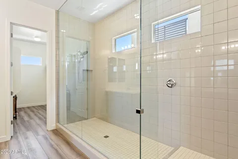 a bathroom with a tub shower and sink