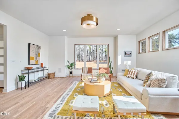 a large kitchen with kitchen island a large counter top space a sink stainless steel appliances and cabinets